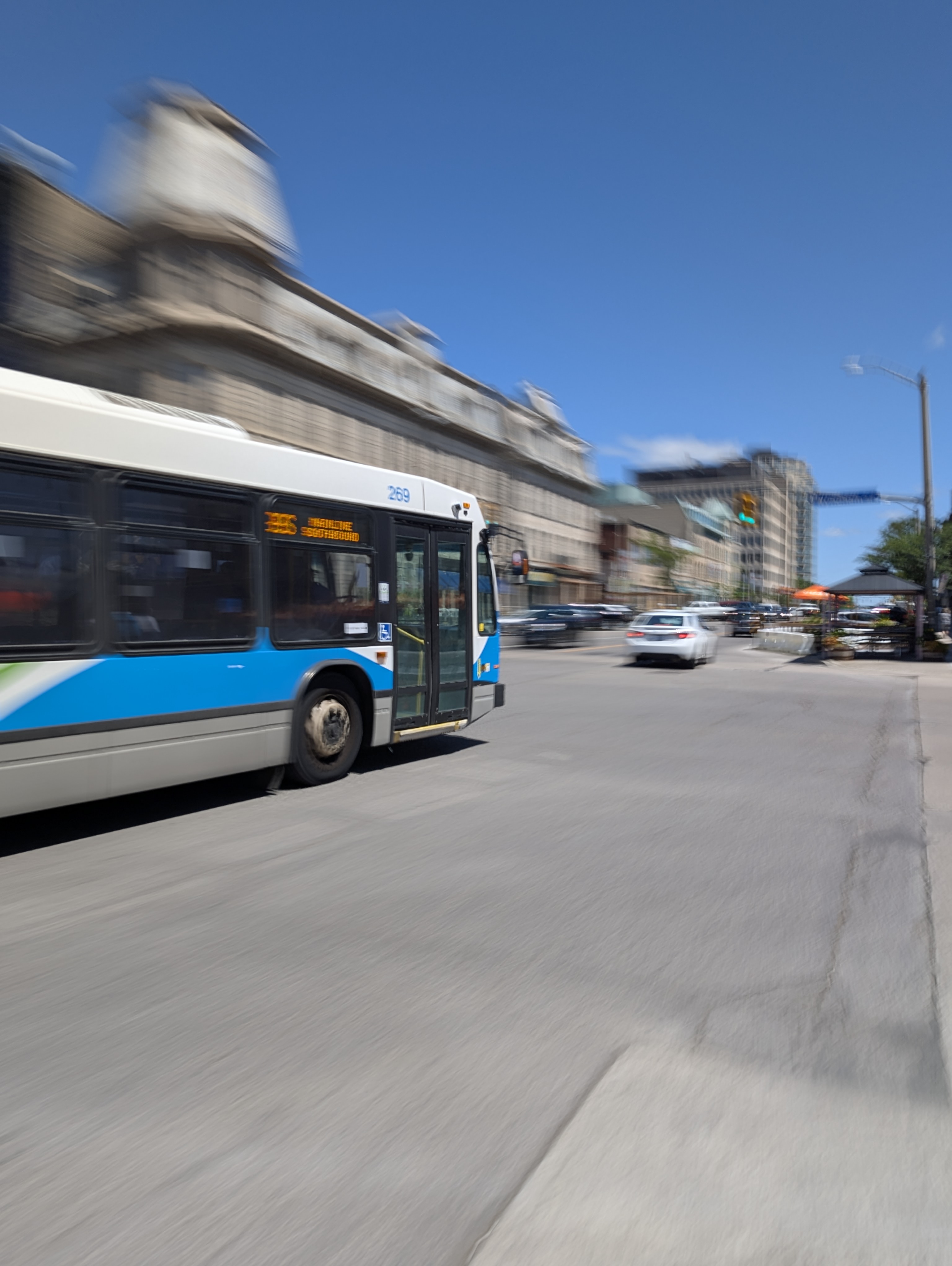 A Guelph city bus races by the camera in a dynamic shot. 